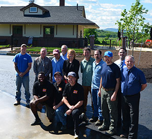 group of people standing in a driveway