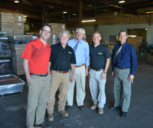 5 men standing in warehouse