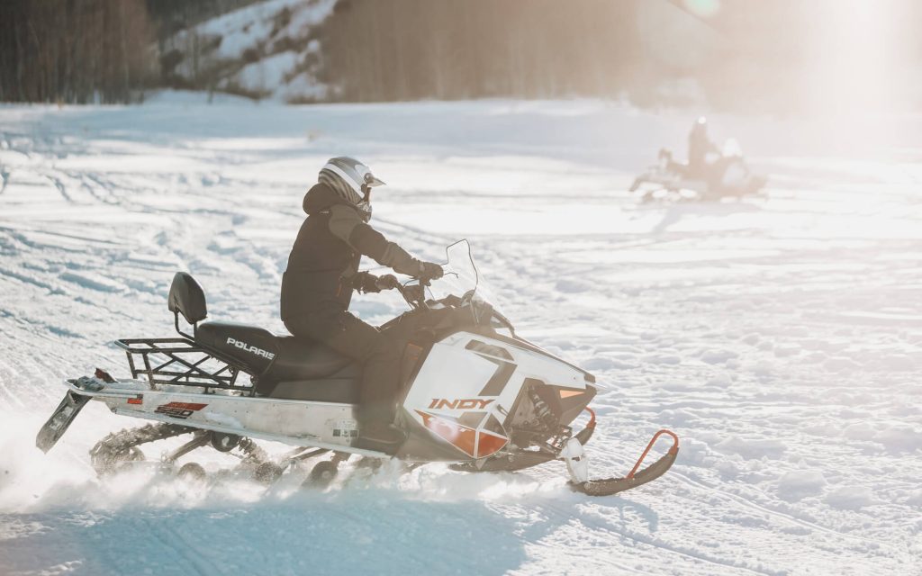 person riding snowmobile